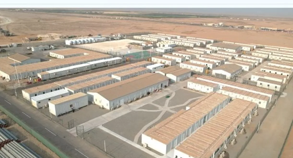 Aerial view of a desert workforce camp made of modular container buildings